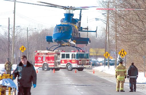 Helicopter taking roll off dumpster accident victim from the scene